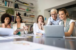 Team collaboration in a modern workspace with diverse individuals discussing network marketing strategies. Reflects Darren and Mike's commitment to mentoring and empowering entrepreneurs in Enagic network marketing leadership.