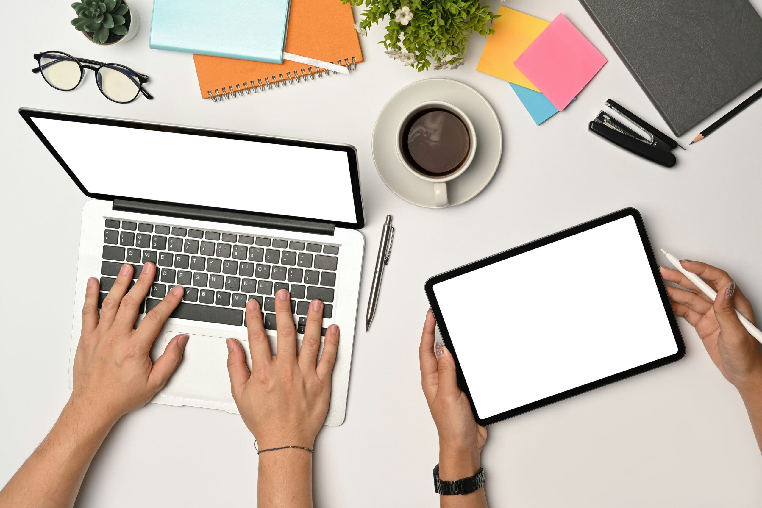 Modern workspace with laptop and tablet showing tools for starting a digital business and managing an online business plan