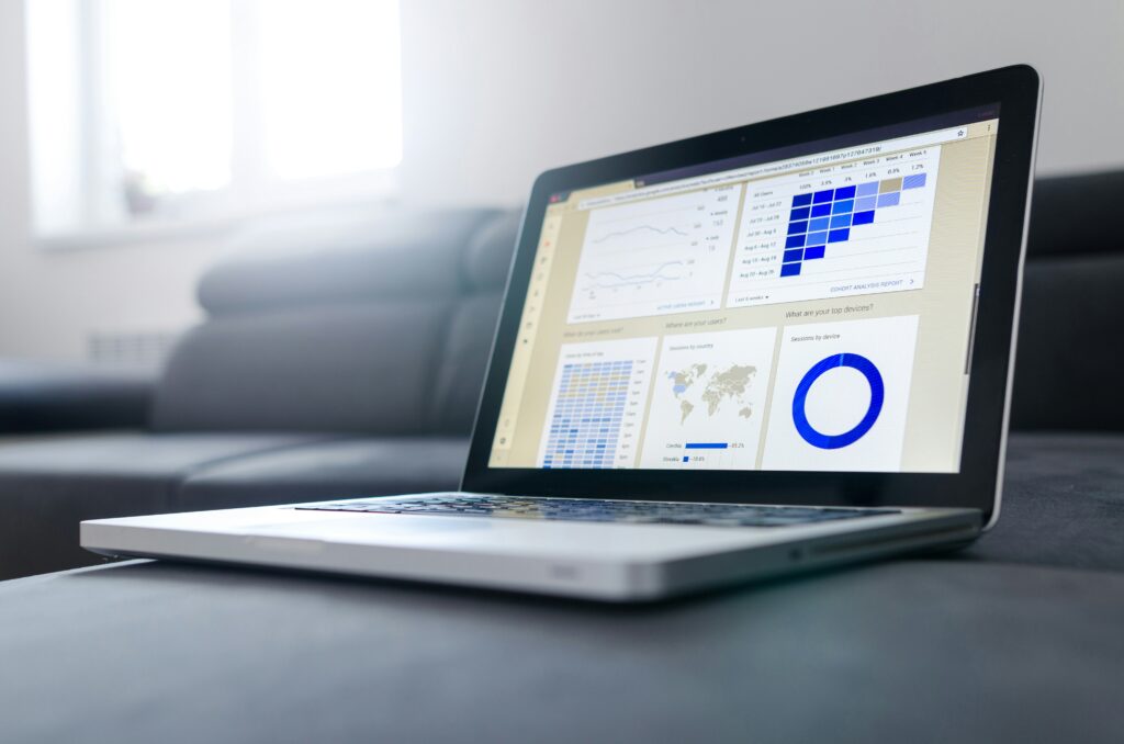 Laptop displaying analytics dashboard for tracking growth in a digital marketing side hustle and online business performance