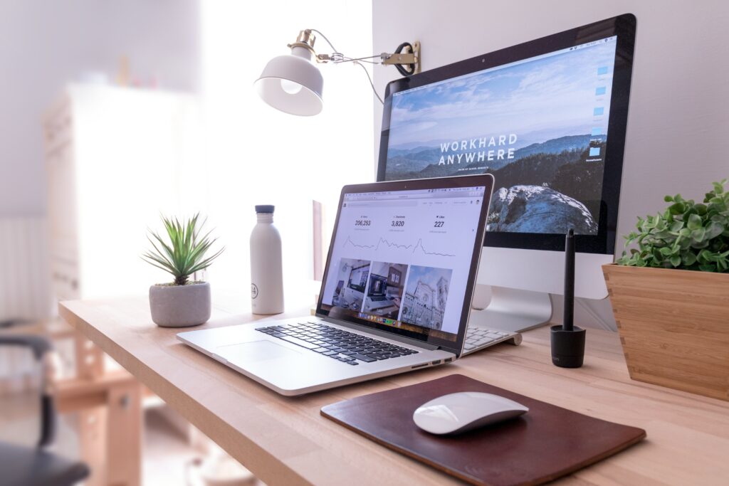 Organized home office setup for building a digital business with laptop, monitor, and productivity tools for online entrepreneurs