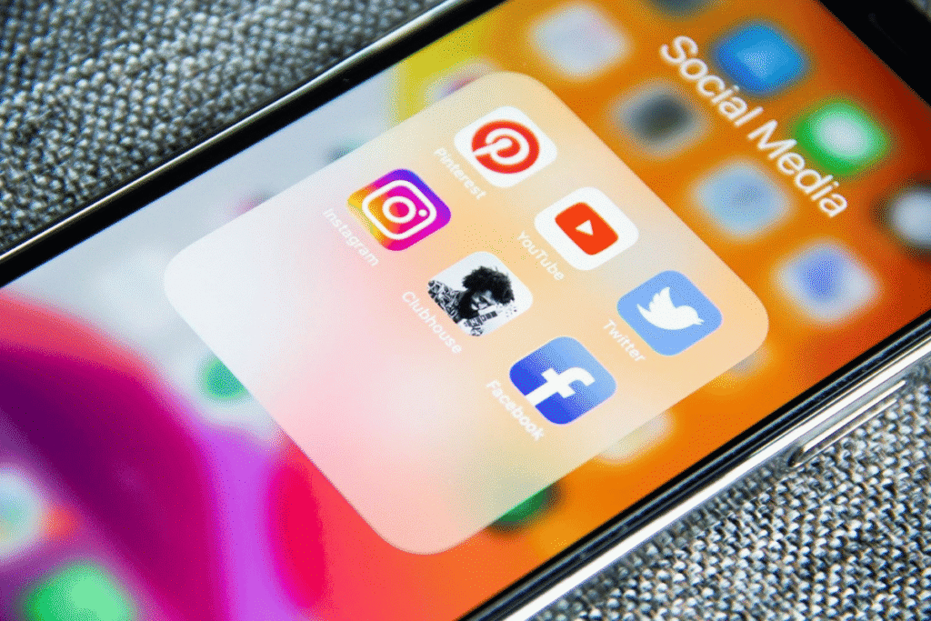 A smartphone screen displaying social media apps, highlighting how Darren and Mike use AI tools to automate social media marketing.