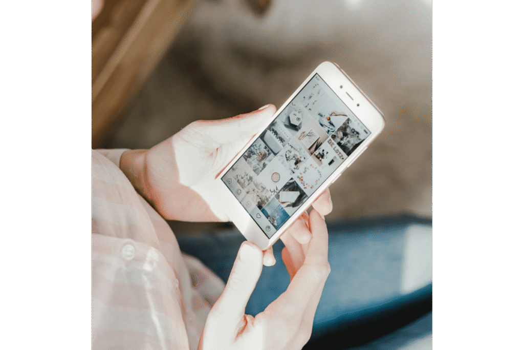 Person scrolling through a social media feed on a smartphone, illustrating strategies to engage followers and connect with a warm market in an online business