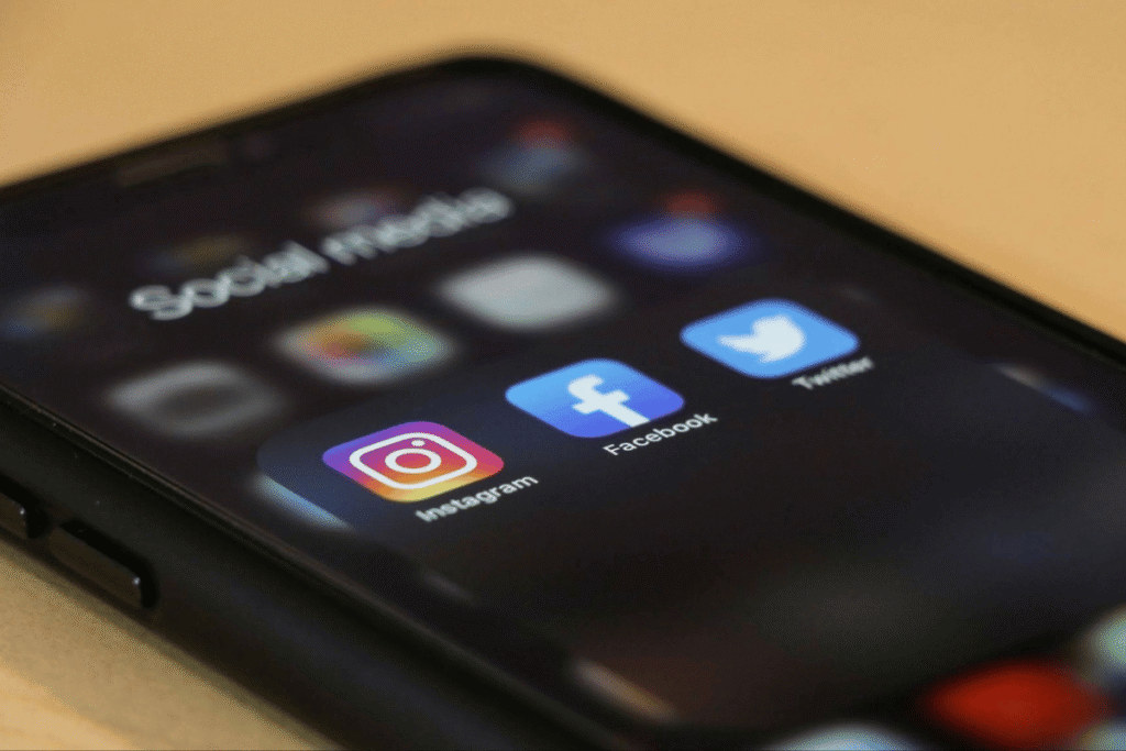 Smartphone screen showing Instagram, Facebook, and Twitter apps used for social media side hustles and digital marketing